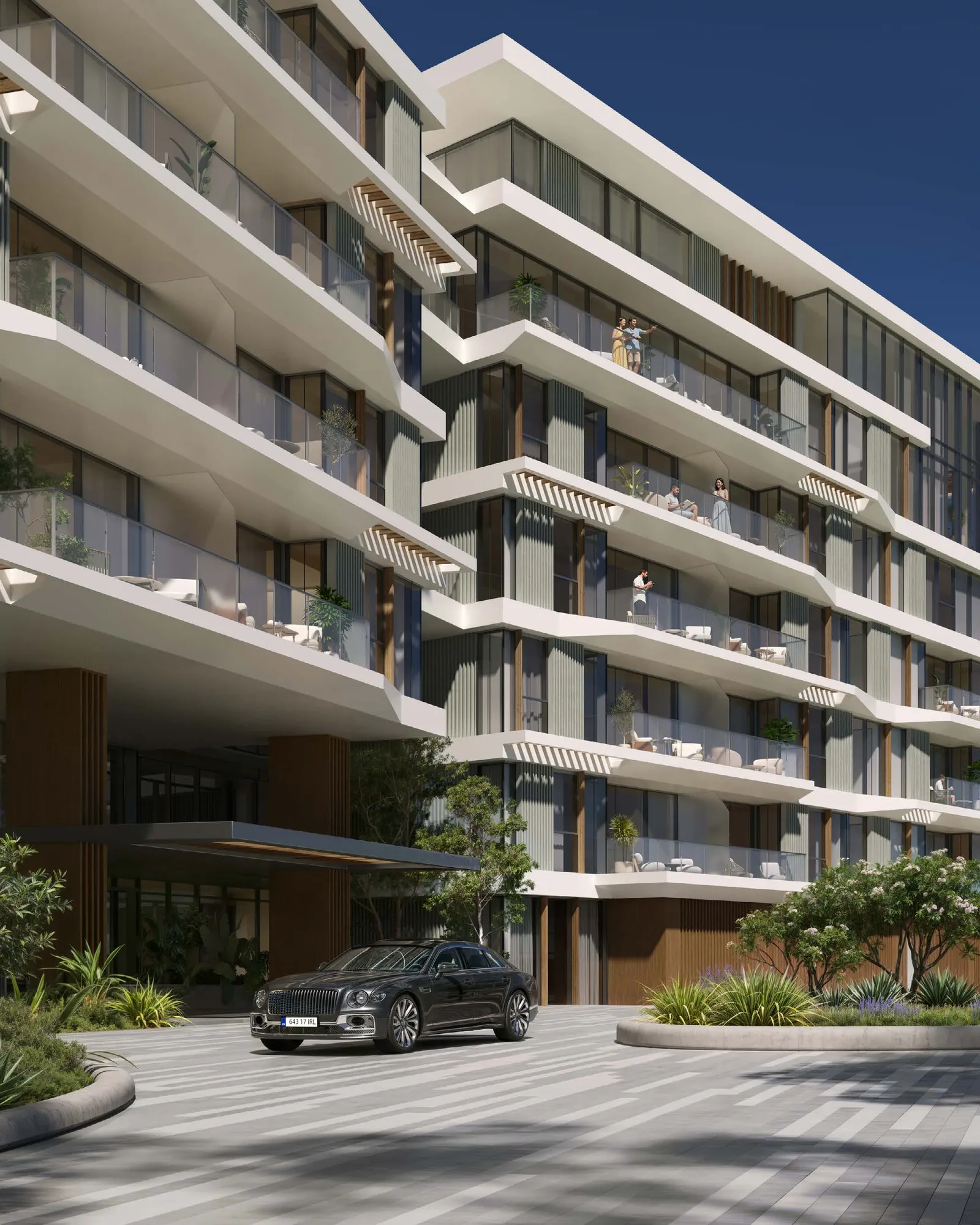 Building facade with layered balconies above a landscaped drop-off